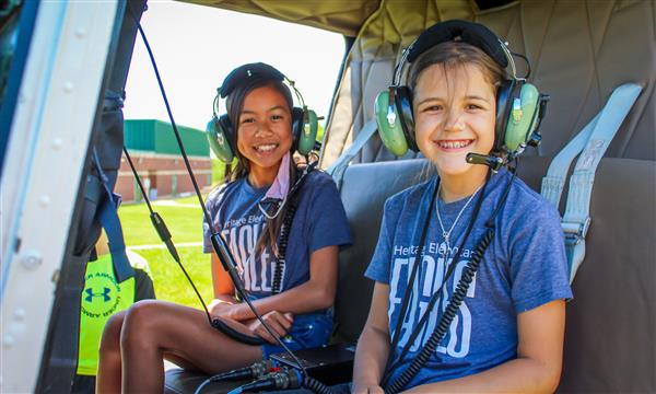 Students sit in helicopter